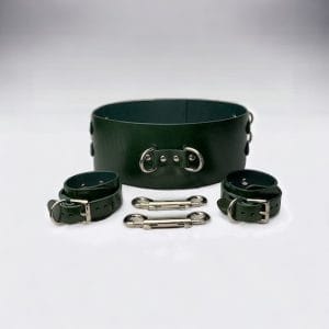 A complete BDSM kit setup featuring restraints, collars, and under-bed gear.
