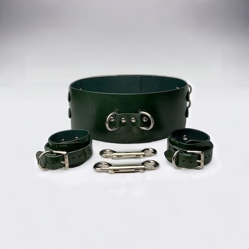 A complete BDSM kit setup featuring restraints, collars, and under-bed gear.